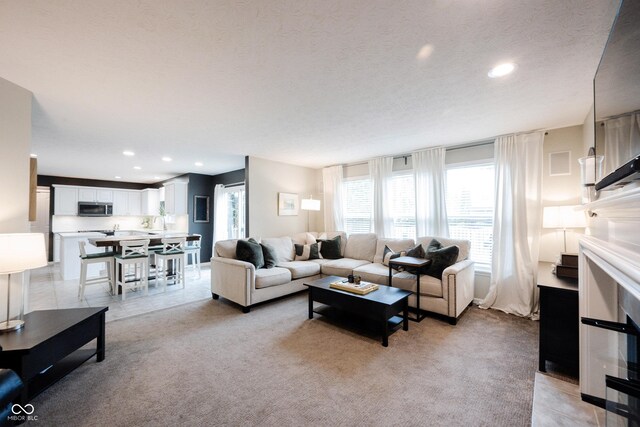 14030 Avalon E Dr, Fishers, IN 46037 - living room with recessed lighting, a textured ceiling, and light colored carpet