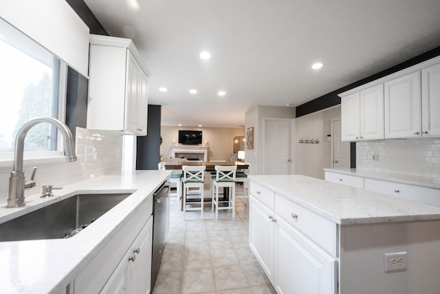 14030 Avalon E Dr, Fishers, IN 46037 - kitchen with a sink, tasteful backsplash, stainless steel dishwasher, white cabinets, and recessed lighting