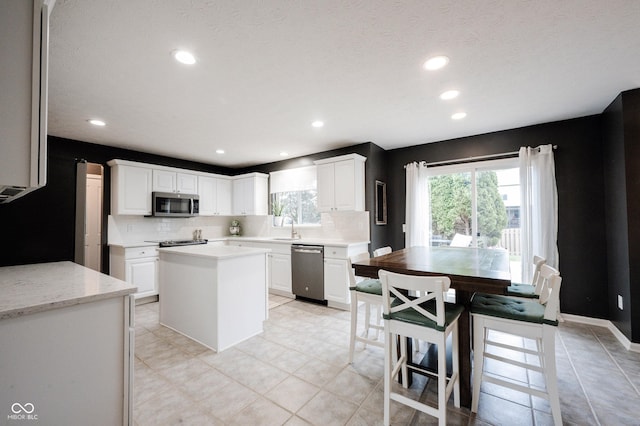 14030 Avalon E Dr, Fishers, IN 46037 - kitchen featuring stainless steel appliances, tasteful backsplash, recessed lighting, and white cabinets