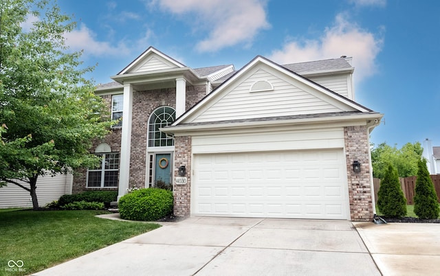 14030 Avalon E Dr, Fishers, IN 46037 - traditional-style home featuring driveway, brick siding, a front yard, a garage, and a shingled roof