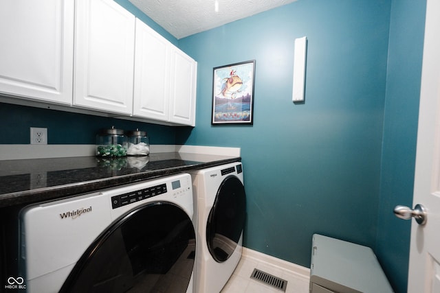 14030 Avalon E Dr, Fishers, IN 46037 - laundry area featuring washing machine and clothes dryer, cabinet space, light tile patterned floors, baseboards, and a textured ceiling