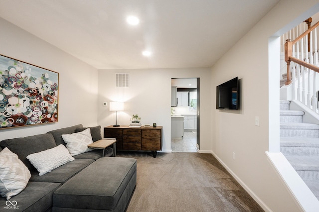 14030 Avalon E Dr, Fishers, IN 46037 - living area with stairway, light colored carpet, and baseboards