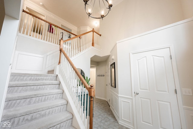 14030 Avalon E Dr, Fishers, IN 46037 - stairs with a chandelier, a high ceiling, and tile patterned floors