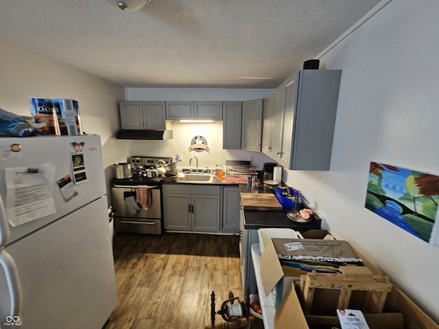 1222 Nichol Ave, Anderson, IN 46016 - kitchen with freestanding refrigerator, gray cabinets, under cabinet range hood, a sink, and a textured ceiling
