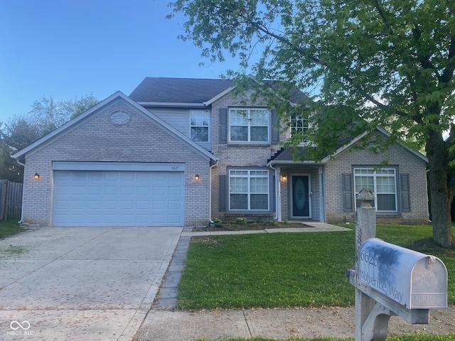 traditional home with driveway, brick siding, a front yard, and a garage