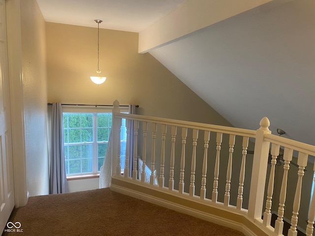 staircase with carpet floors and vaulted ceiling with beams