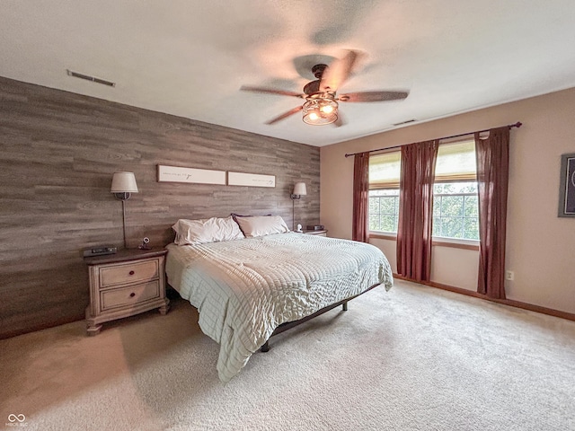 8798 Surrey Dr, Pendleton, IN 46064 - carpeted bedroom with wooden walls, a ceiling fan, and baseboards