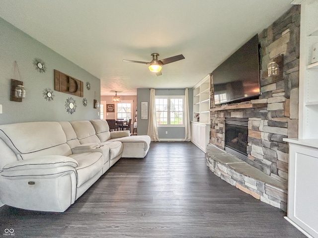 8798 Surrey Dr, Pendleton, IN 46064 - living area featuring dark wood finished floors, a ceiling fan, a fireplace, baseboards, and built in features