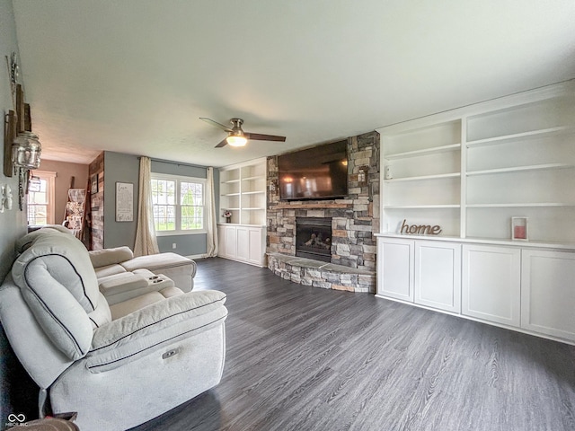 8798 Surrey Dr, Pendleton, IN 46064 - living room with dark wood-style flooring, a fireplace, a ceiling fan, built in features, and baseboards