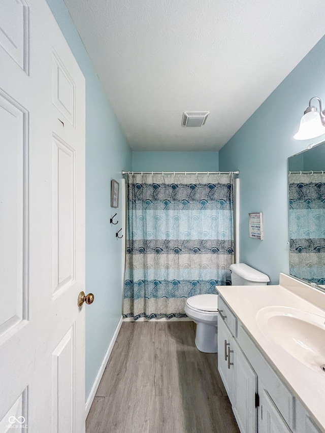 8798 Surrey Dr, Pendleton, IN 46064 - bathroom with wood finished floors, vanity, toilet, and curtained shower