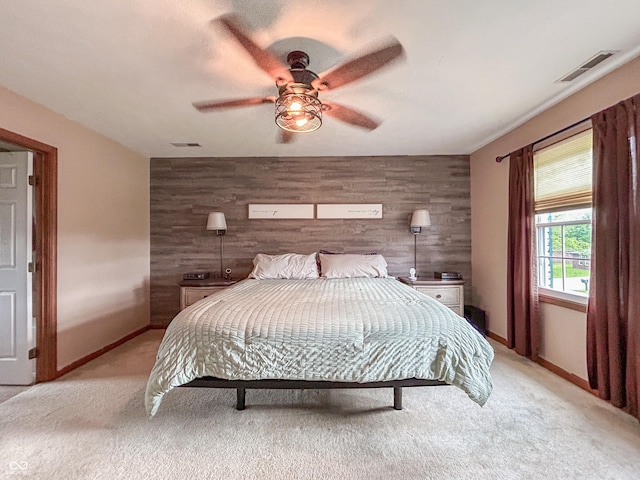 8798 Surrey Dr, Pendleton, IN 46064 - bedroom featuring light colored carpet, baseboards, ceiling fan, an accent wall, and wooden walls