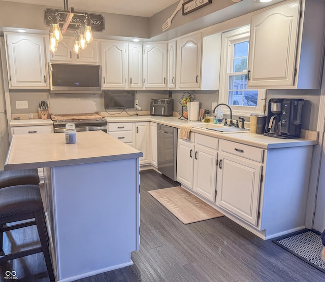 8798 Surrey Dr, Pendleton, IN 46064 - kitchen featuring stainless steel appliances, white cabinets, dark wood finished floors, and light countertops