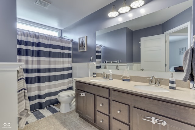 1476 Anon Ct, Greenwood, IN 46143 - full bath with double vanity, toilet, tile patterned floors, and a shower with curtain