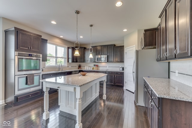 1476 Anon Ct, Greenwood, IN 46143 - kitchen with appliances with stainless steel finishes, a kitchen bar, dark brown cabinetry, backsplash, and dark wood-type flooring