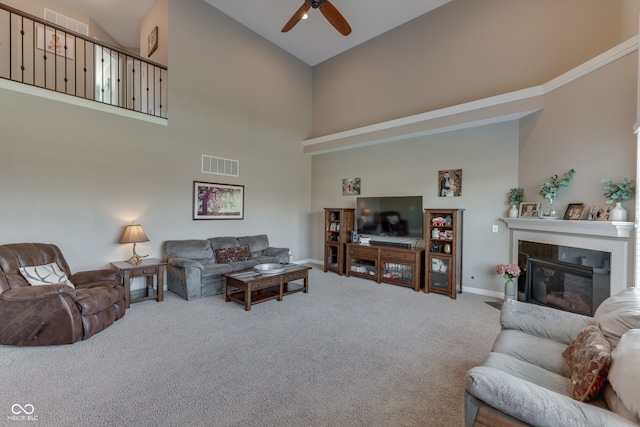 1476 Anon Ct, Greenwood, IN 46143 - living area with high vaulted ceiling, ceiling fan, carpet floors, a glass covered fireplace, and baseboards