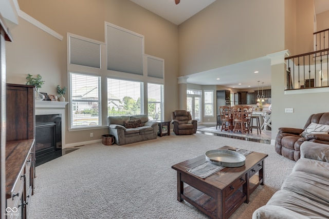 1476 Anon Ct, Greenwood, IN 46143 - living room featuring a high ceiling, carpet, baseboards, and plenty of natural light