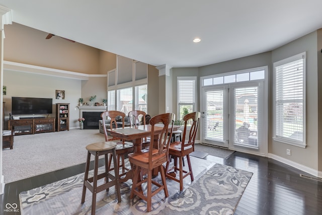 1476 Anon Ct, Greenwood, IN 46143 - dining room featuring dark wood-style floors, a glass covered fireplace, baseboards, and recessed lighting