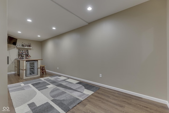 1476 Anon Ct, Greenwood, IN 46143 - unfurnished living room featuring a dry bar, baseboards, wood finished floors, and recessed lighting