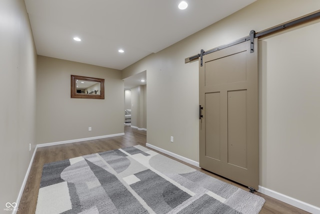 1476 Anon Ct, Greenwood, IN 46143 - foyer entrance with a barn door, wood finished floors, recessed lighting, and baseboards