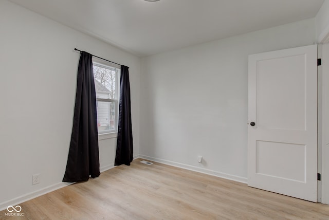 1517 Wallace Ave, Indianapolis, IN 46201 - empty room featuring baseboards, visible vents, and light wood-type flooring