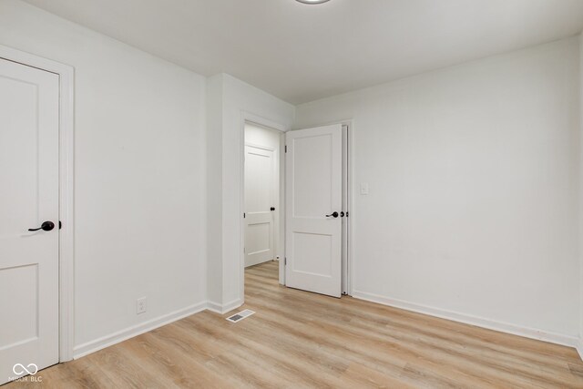 1517 Wallace Ave, Indianapolis, IN 46201 - unfurnished bedroom featuring light wood-type flooring, baseboards, and visible vents