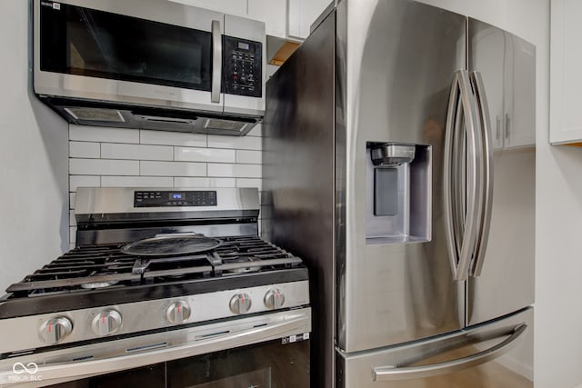 1517 Wallace Ave, Indianapolis, IN 46201 - kitchen with white cabinetry, stainless steel appliances, and tasteful backsplash