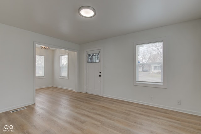 1517 Wallace Ave, Indianapolis, IN 46201 - foyer featuring light wood finished floors, baseboards, and visible vents