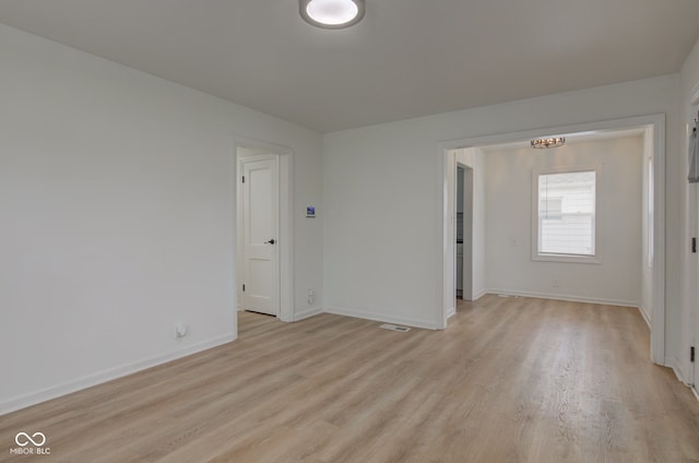 1517 Wallace Ave, Indianapolis, IN 46201 - unfurnished room with baseboards, visible vents, light wood-style flooring, and a chandelier
