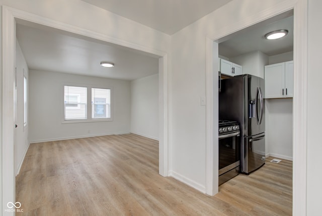 1517 Wallace Ave, Indianapolis, IN 46201 - kitchen featuring white cabinets, appliances with stainless steel finishes, baseboards, and light wood-style floors