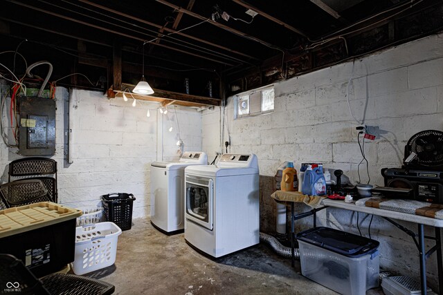 washroom featuring washing machine and clothes dryer, laundry area, and electric panel