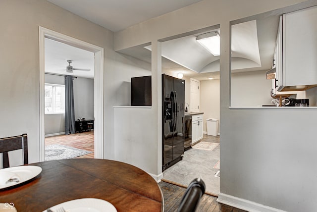 dining room with light wood-style flooring, baseboards, and a ceiling fan