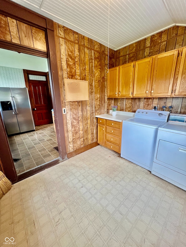 washroom with light floors and washer and dryer
