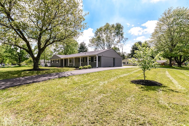 7118 Mikesell Dr, Indianapolis, IN 46260 - ranch-style house featuring asphalt driveway, an attached garage, and a front lawn