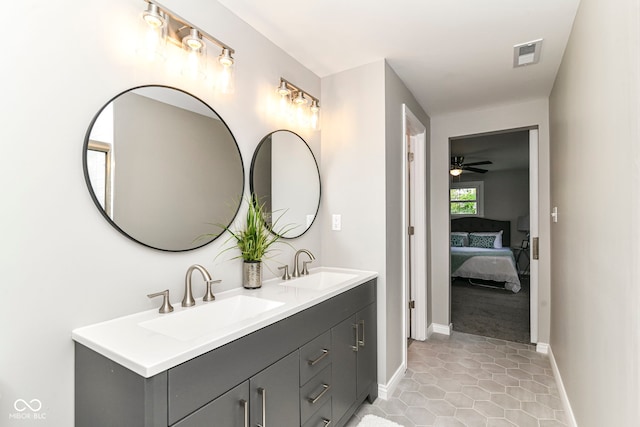 7118 Mikesell Dr, Indianapolis, IN 46260 - ensuite bathroom featuring baseboards, double vanity, tile patterned floors, and a ceiling fan