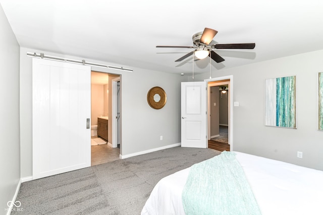 7118 Mikesell Dr, Indianapolis, IN 46260 - bedroom featuring carpet floors, baseboards, a barn door, ceiling fan, and connected bathroom