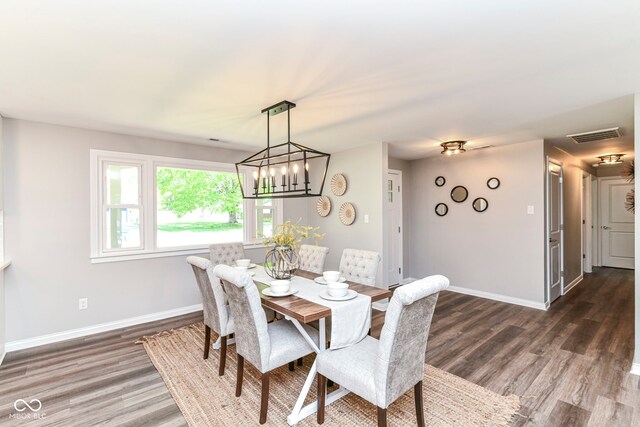 7118 Mikesell Dr, Indianapolis, IN 46260 - dining room featuring dark wood finished floors, baseboards, and a chandelier