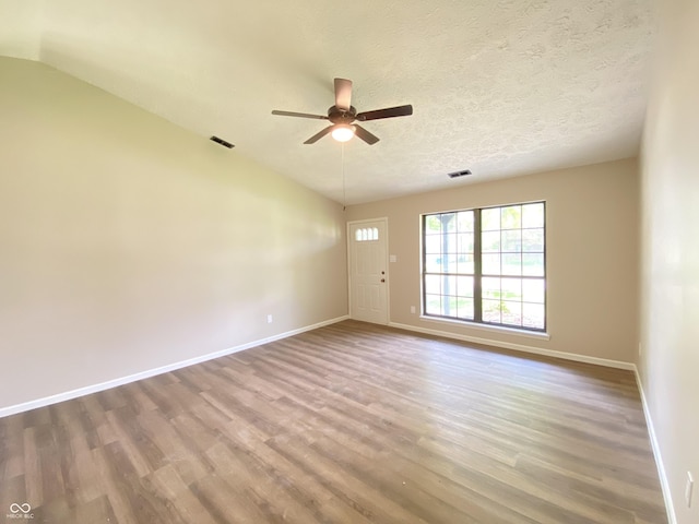 empty room featuring baseboards, ceiling fan, and wood finished floors