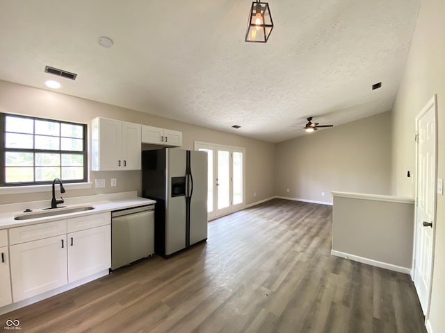 kitchen with a wealth of natural light, refrigerator with ice dispenser, a sink, and stainless steel dishwasher