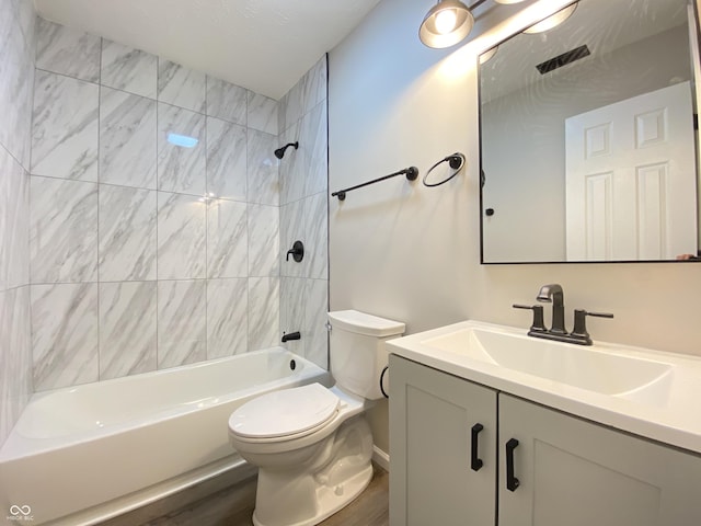 full bath with toilet, wood finished floors, vanity, visible vents, and bathing tub / shower combination