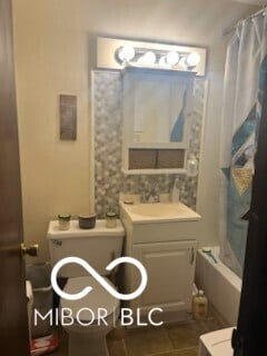 400-416 S Pennsylvania St, Greenfield, IN 46140 - full bathroom featuring tile patterned floors, vanity, toilet, and shower / bath combo with shower curtain