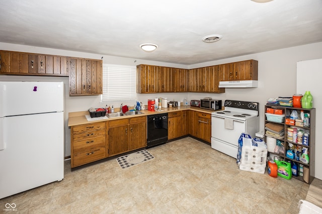 400-416 S Pennsylvania St, Greenfield, IN 46140 - kitchen with white appliances, under cabinet range hood, a sink, light countertops, and brown cabinetry
