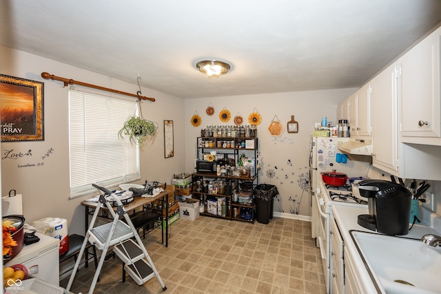 400-416 S Pennsylvania St, Greenfield, IN 46140 - kitchen featuring a sink, white cabinets, range hood, light countertops, and baseboards