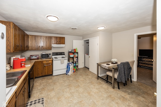 400-416 S Pennsylvania St, Greenfield, IN 46140 - kitchen featuring white electric range oven, stainless steel microwave, under cabinet range hood, a sink, and light countertops