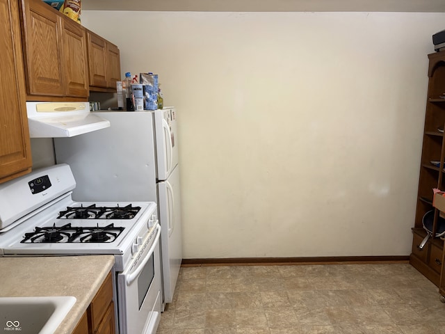 400-416 S Pennsylvania St, Greenfield, IN 46140 - kitchen featuring gas range gas stove, ventilation hood, brown cabinets, and light countertops