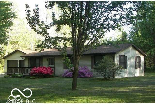 575 Mill Spgs, Coatesville, IN 46121 - back of property featuring an attached garage and a yard