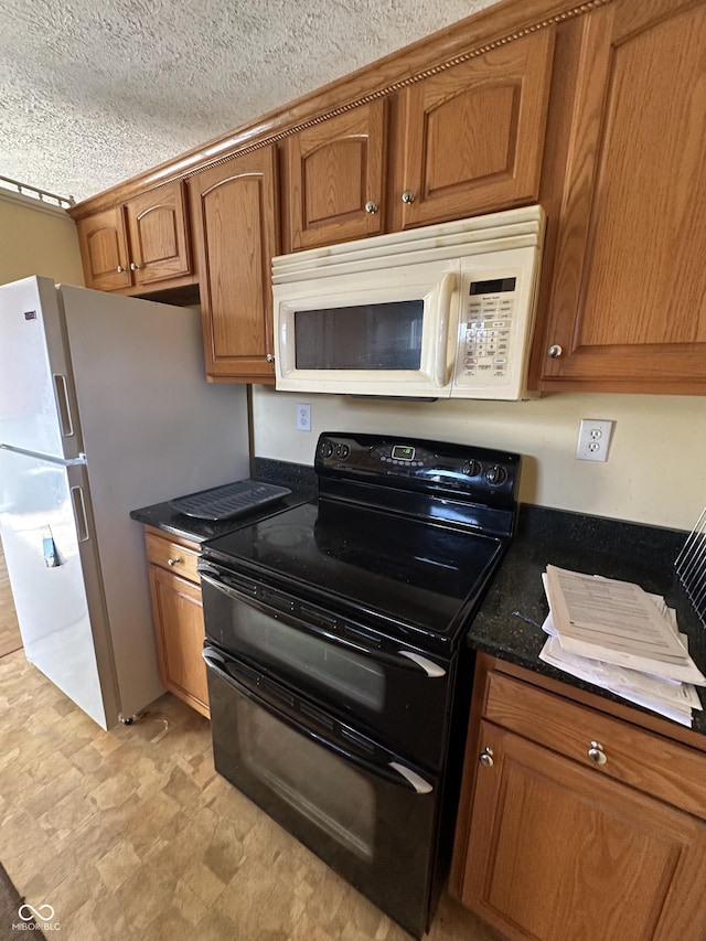 575 Mill Spgs, Coatesville, IN 46121 - kitchen featuring dark stone countertops, a textured ceiling, brown cabinetry, and white appliances