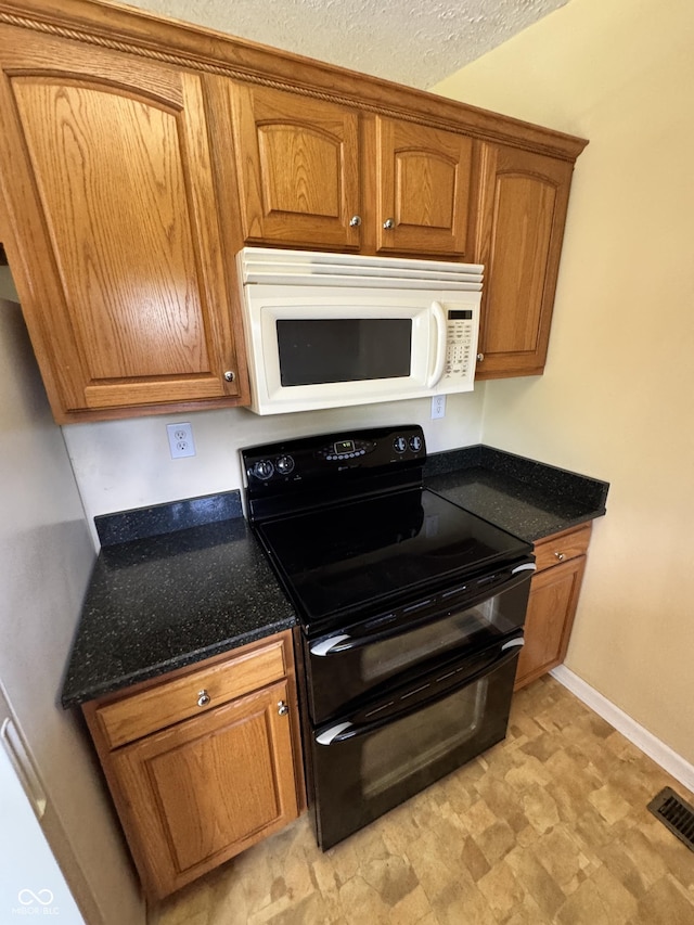 575 Mill Spgs, Coatesville, IN 46121 - kitchen with white microwave, double oven range, and brown cabinetry