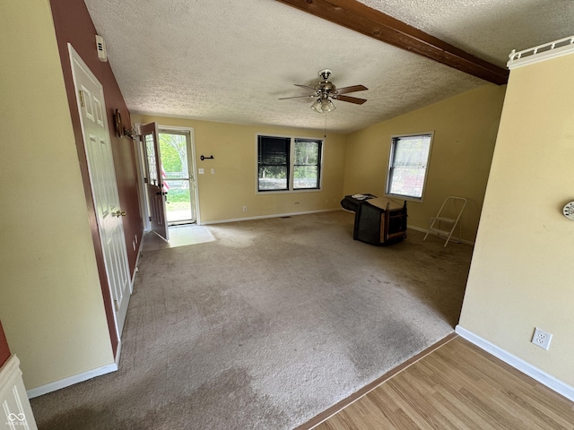 575 Mill Spgs, Coatesville, IN 46121 - unfurnished living room with a textured ceiling, a ceiling fan, baseboards, and wood finished floors