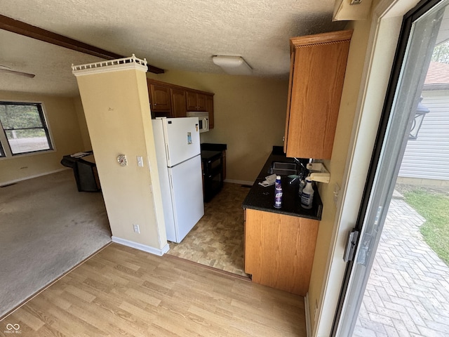 575 Mill Spgs, Coatesville, IN 46121 - kitchen featuring white appliances, a textured ceiling, and baseboards