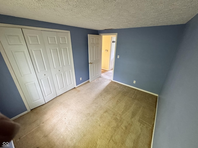 575 Mill Spgs, Coatesville, IN 46121 - unfurnished bedroom featuring carpet, a closet, baseboards, and a textured ceiling